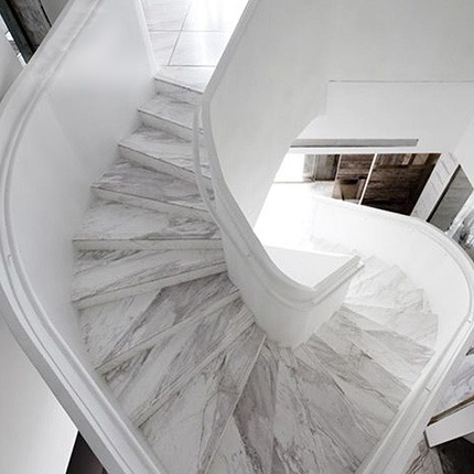 Curved staircase finished with fabricated nano glass stone components